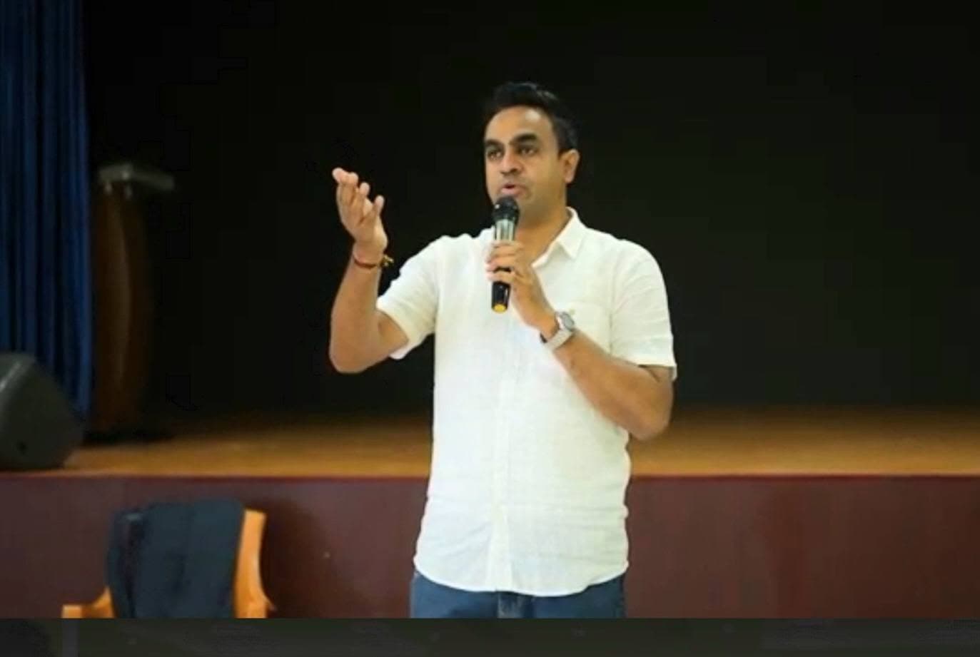Manesh addressing students in an auditorium